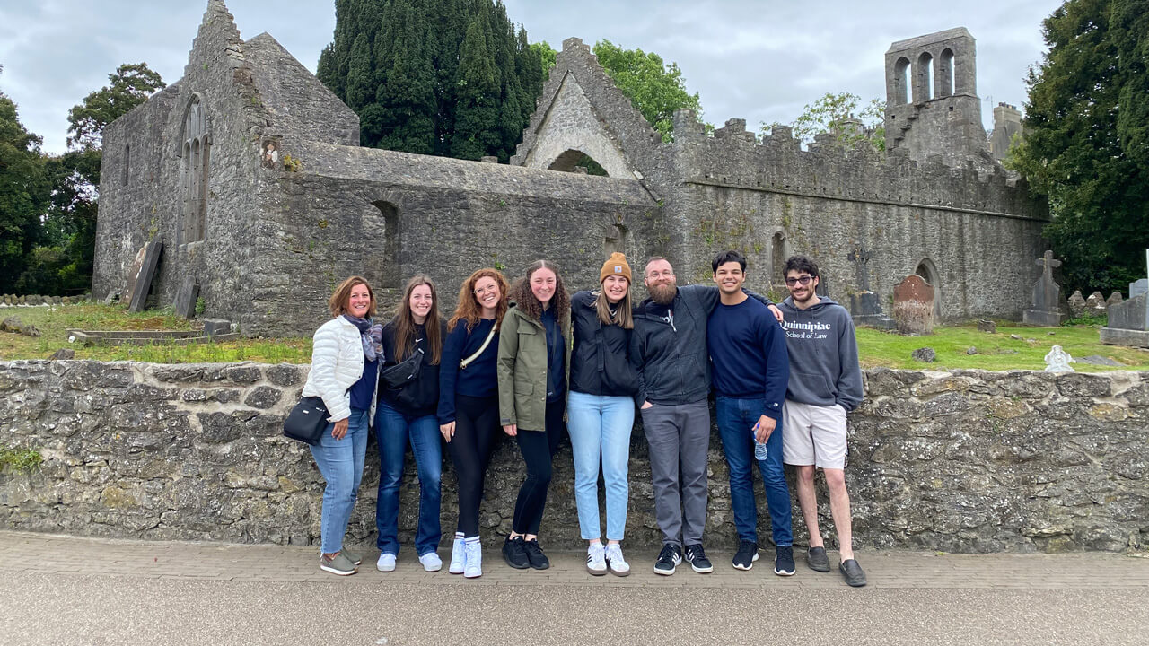 Group of School of Law students in front of an old cemetery