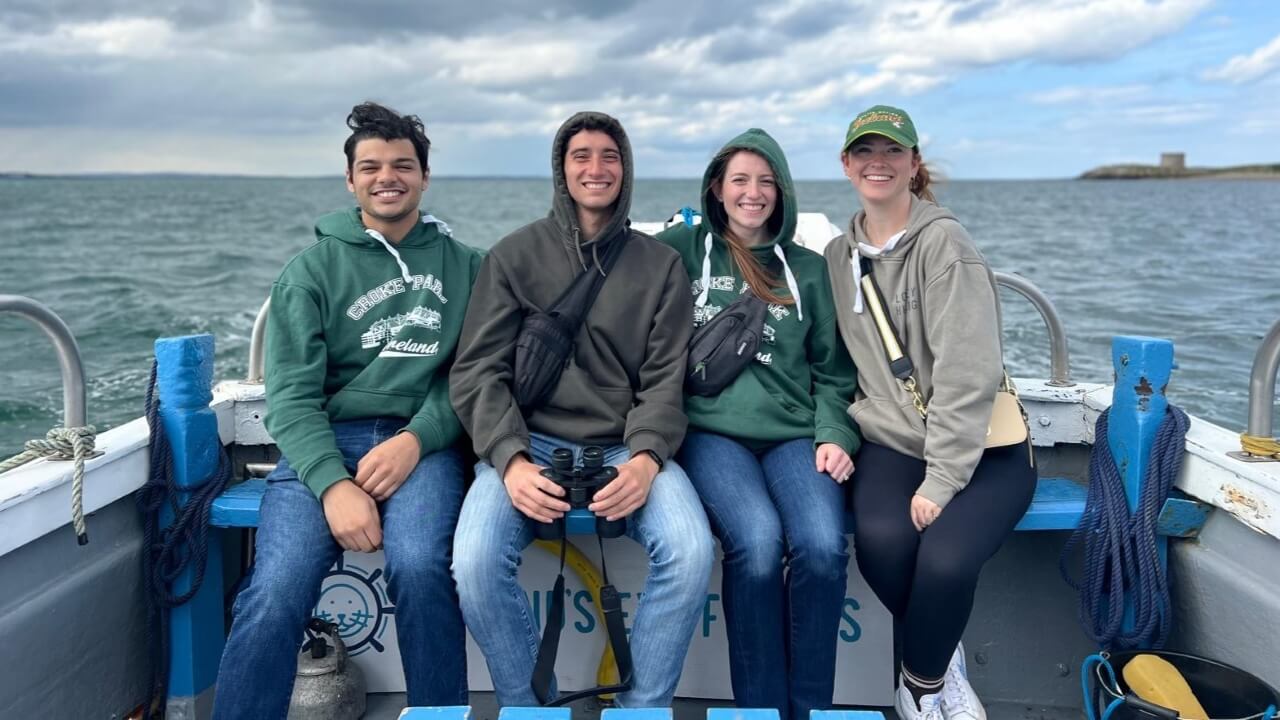 Group of students sitting on a boat in the water