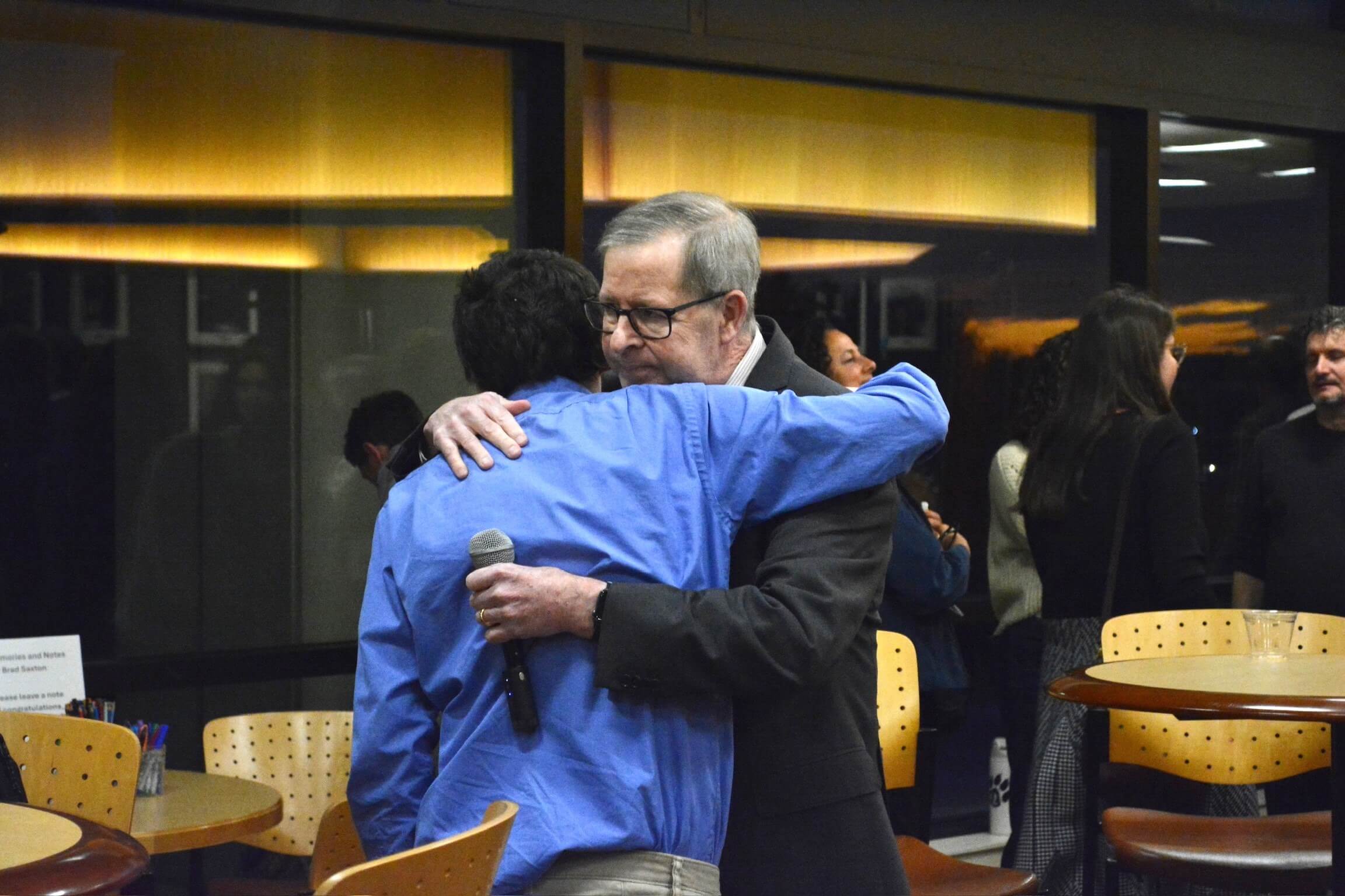 Brad Saxton hugs peer